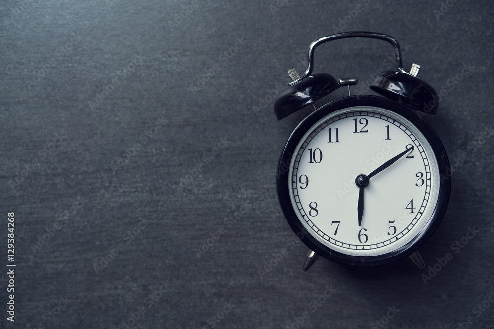 Retro alarm clock on black background Retro alarm clock on black background