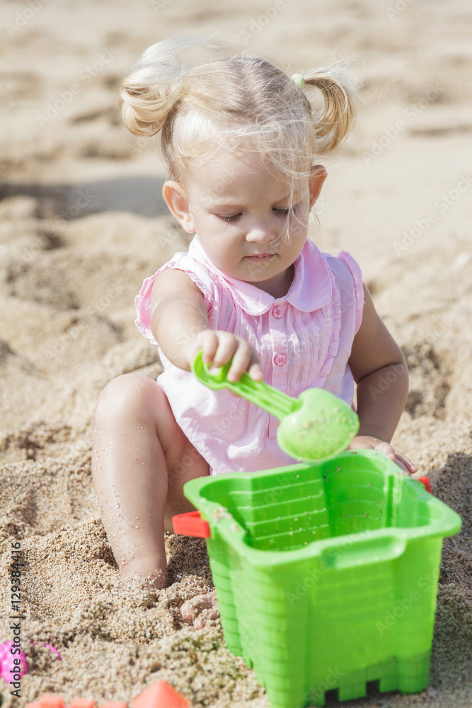 little baby girl playing sand toys at the beach little baby girl playing sand toys at the beach
