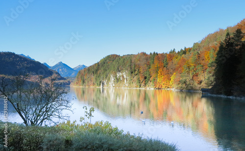 Mountain autumn landscape with colorful forest. Blue sky.