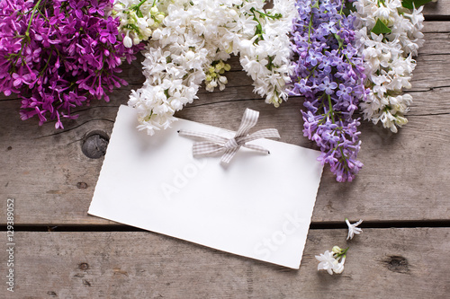 Background with fresh aromatic lilac flowers  and empty tag on v