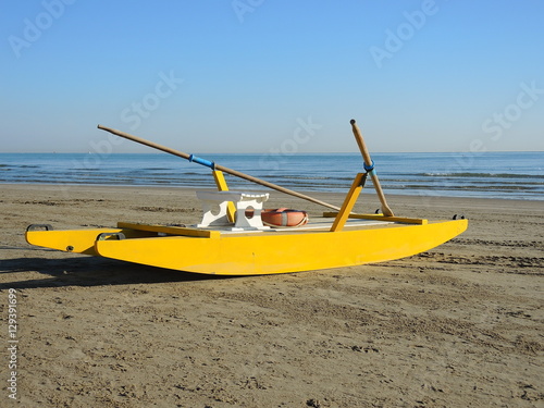 Yellow rescue rawboat on Italian beach. Adriatic sea. Emilia Romagna. Italy
