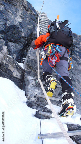 mountain climber on a rope ladder on the Doldenhorn in the Swiss Alps