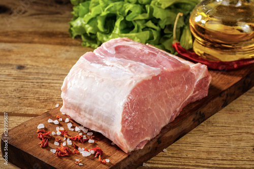 Raw pork loin with salt and herbs.