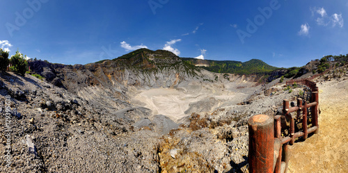 Panoramic view of Tangkuban Perahu crater, showing beautiful and huge mountain crater, at the morning,illuminated by sunlight. There also a blue sky and beautiful cloud photo