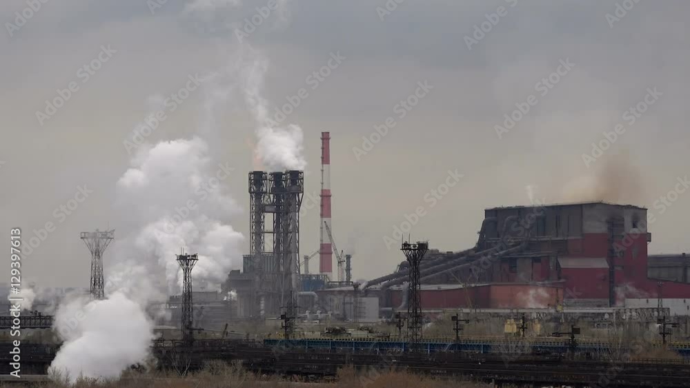 Atmospheric Air Pollution From Industrial Smoke Now. Pipes Steel Plant. Thick Smoke and Steam of Steel Production Workshops. Atmospheric Air Pollution From Industrial Smoke Now. Pipes Steel Plant. Thick Smoke and Steam of Steel Production Workshops.