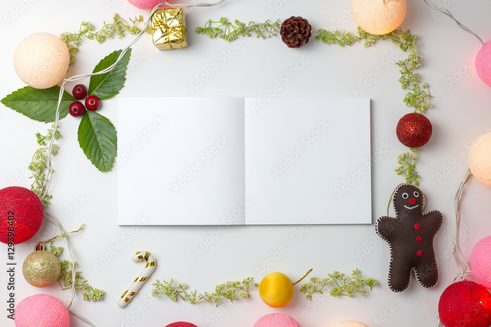 Fototapeta Blank notebook with Christmas decorations on white background. flat lay, Christmas concept.