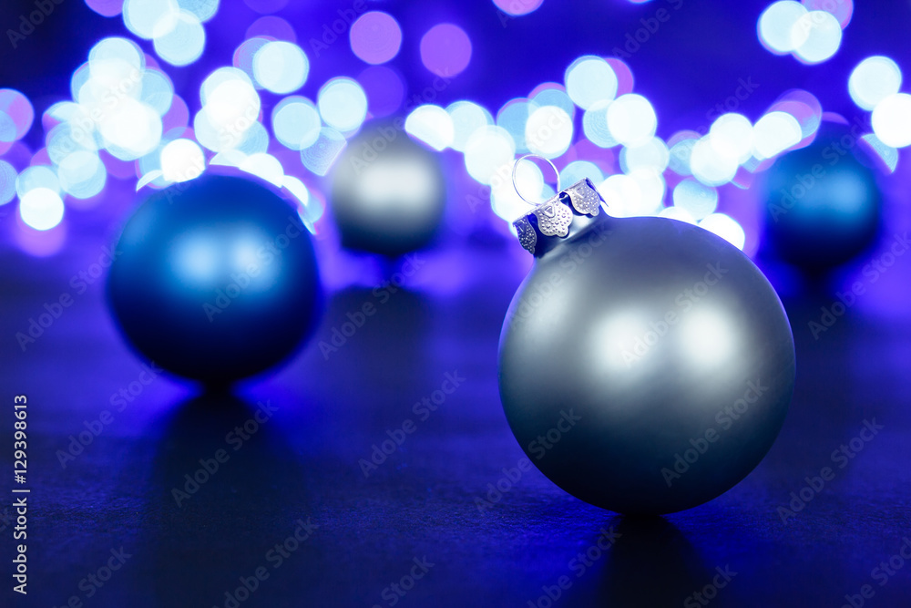 Blue christmas ball and blured purple lights at the background Blue christmas ball and blured purple lights at the background