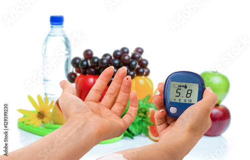 glucometer for glucose level and healthy organic food on a white background. Diabetes concept