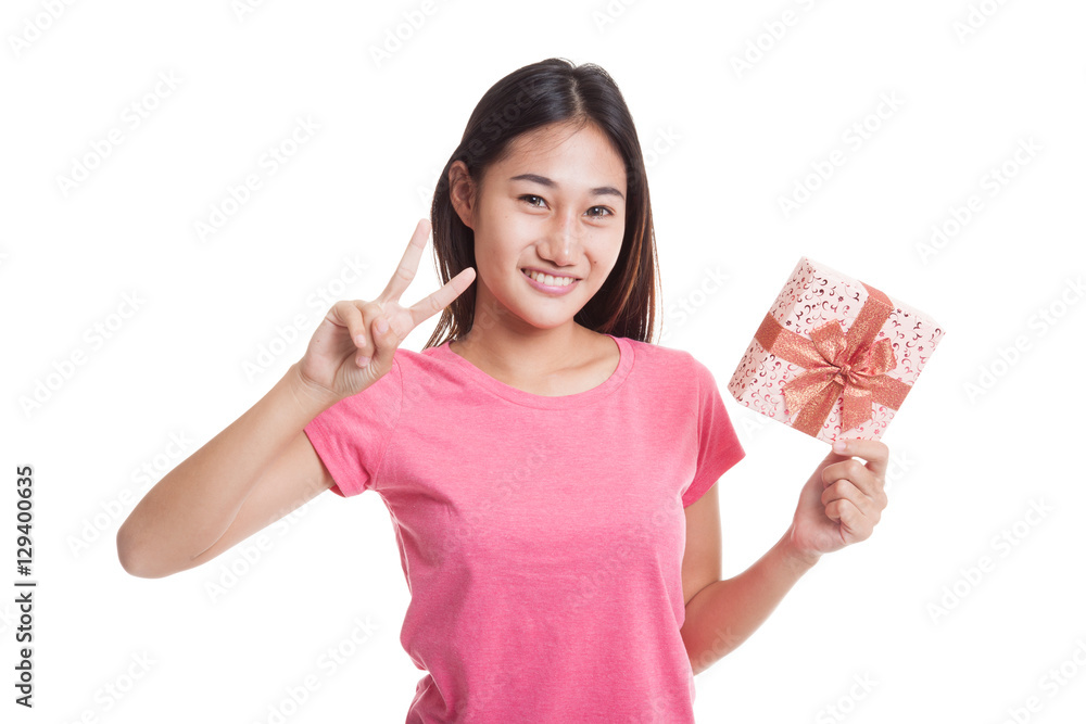 Asian woman show victory sign with a gift box. Asian woman show victory sign with a gift box.