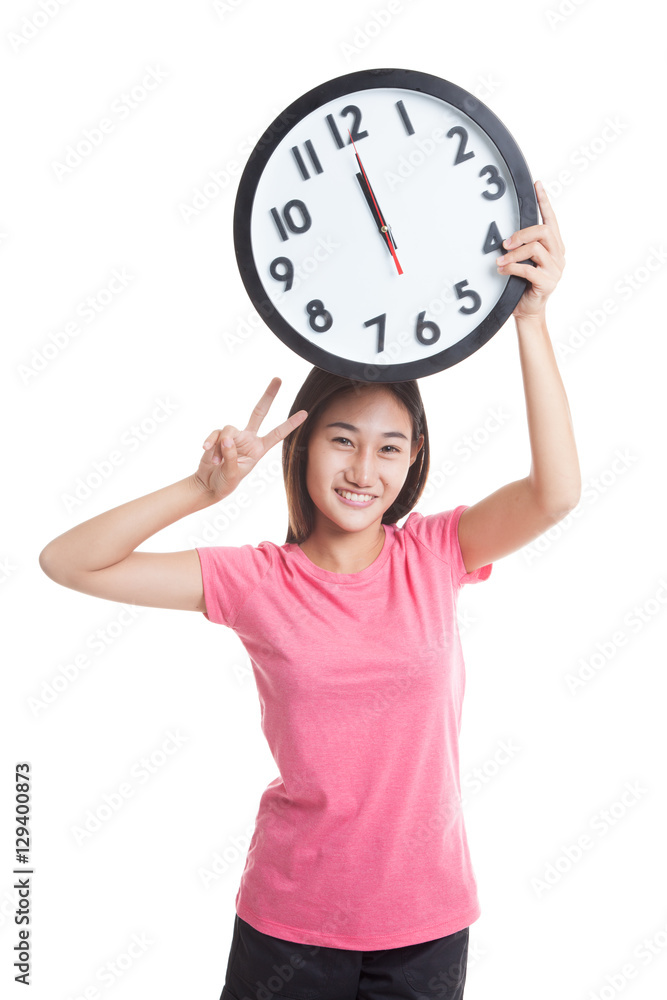 Young Asian woman show victory sign with a clock. Young Asian woman show victory sign with a clock.
