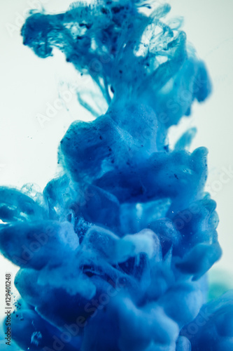 The blue dye in the water. Abstract background. Wallpaper. Concept art
