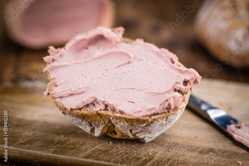 Wooden table with Liverwurst Sandwich (selective focus)