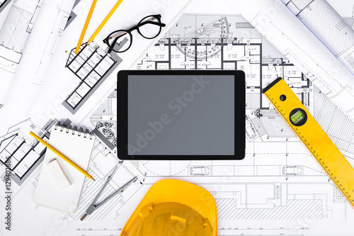Construction plans with Tablet, drawing and working Tools