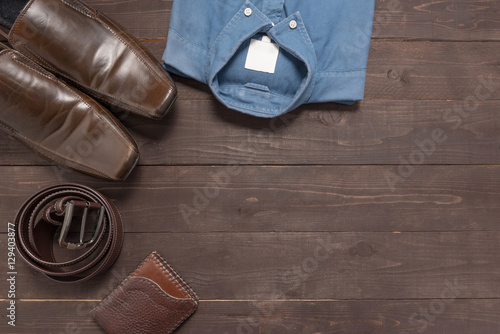 Elegant set: brown men's shoes, brown leather belt, blue shirt,