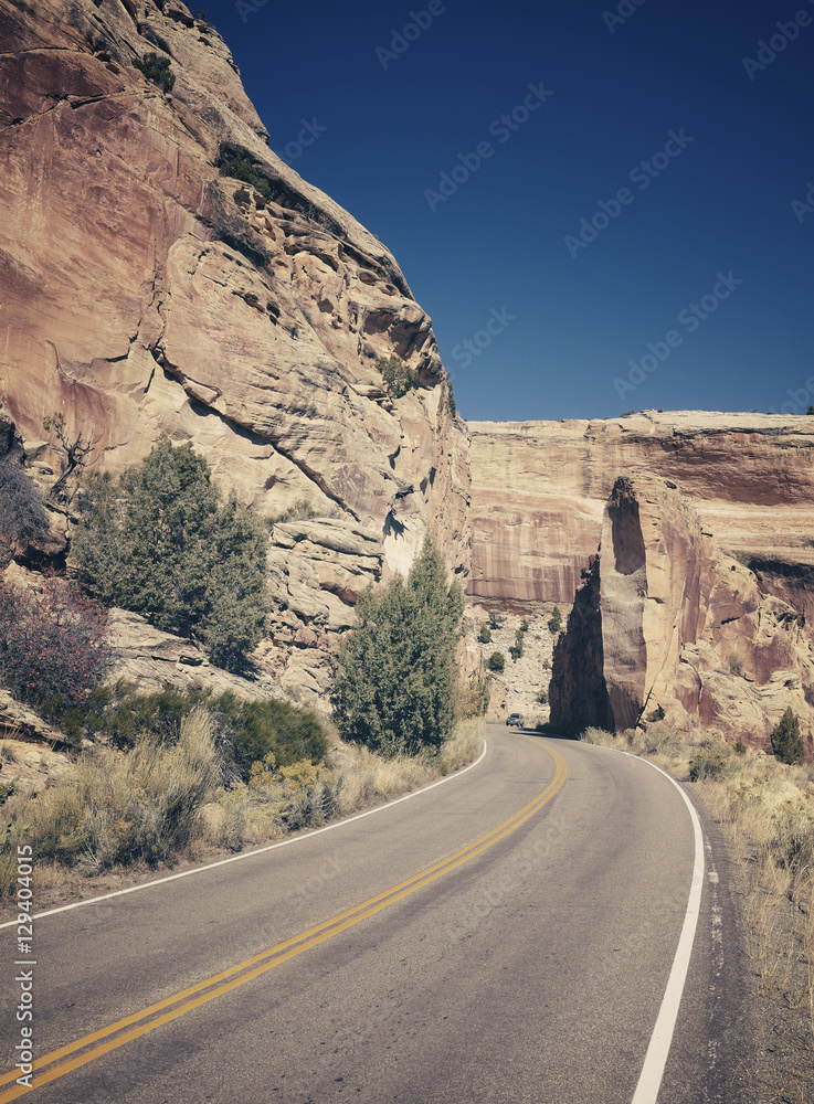 Retro stylized scenic road, travel concept background, Colorado National Monument, Colorado, USA. Retro stylized scenic road, travel concept background, Colorado National Monument, Colorado, USA.