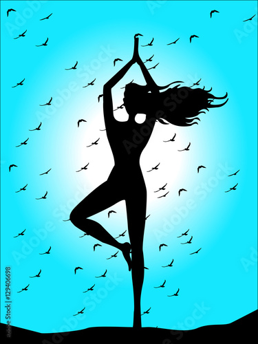 silhouette of woman doing yoga on blue sky background