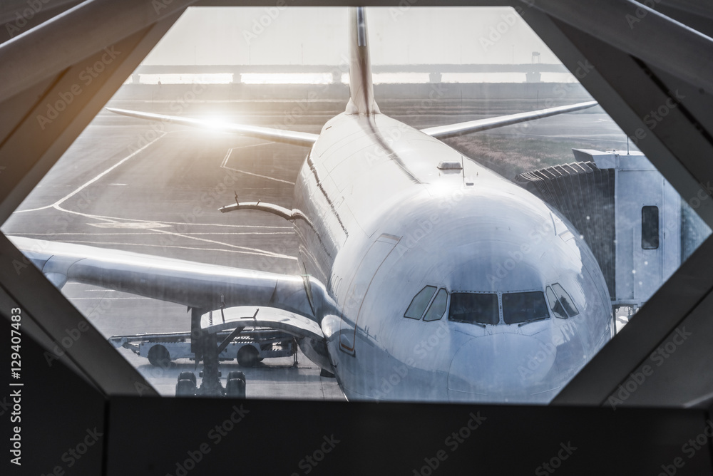 Airplanes on runway,seen through window.