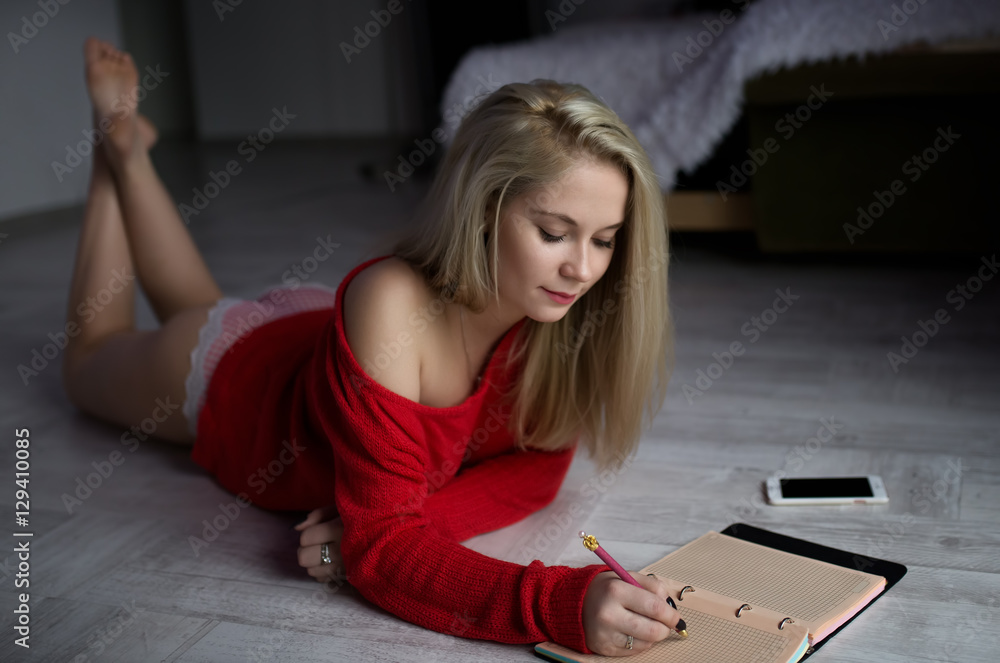 sexy girl on the floor with a notebook Stock Photo | Adobe Stock