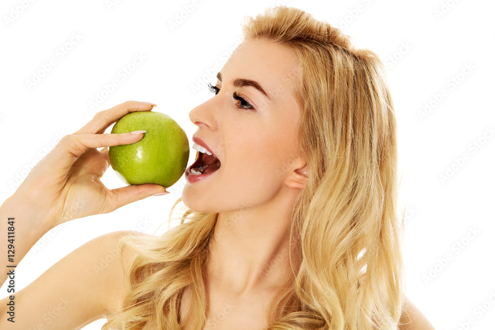 Young happy woman eating fresh green apple Young happy woman eating fresh green apple