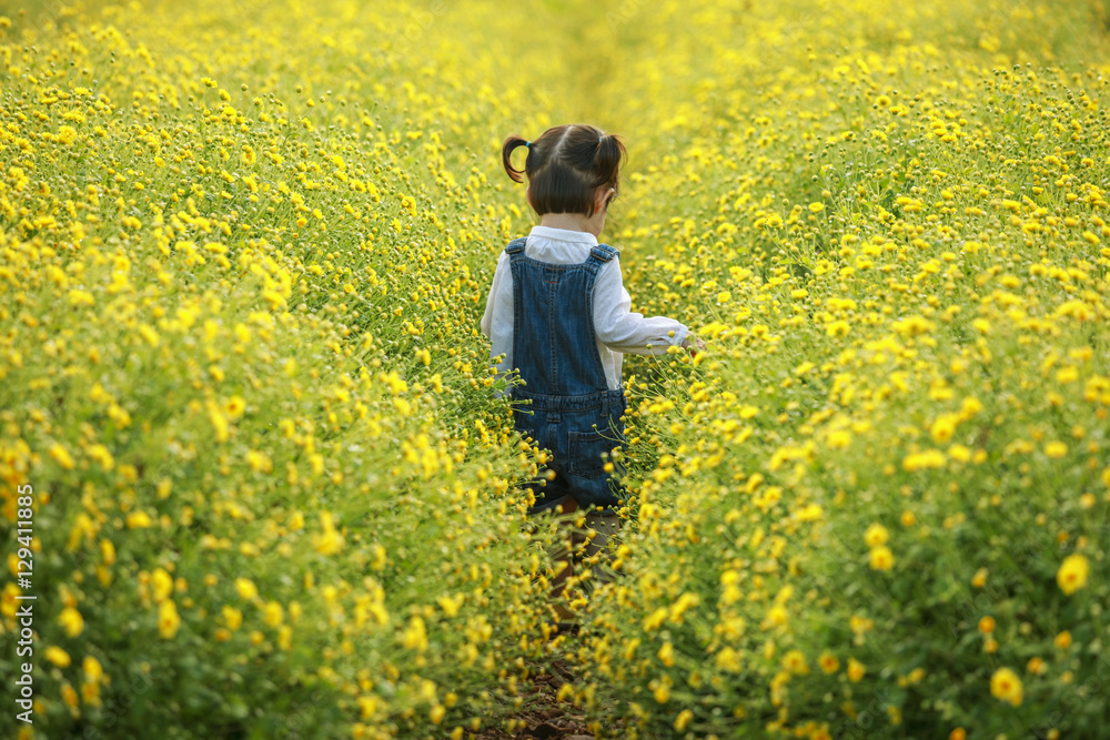 Cute little laughing girl or asian little girl walking in the fi