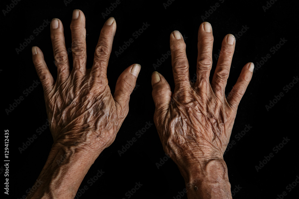 Old hands on a black background Old hands on a black background