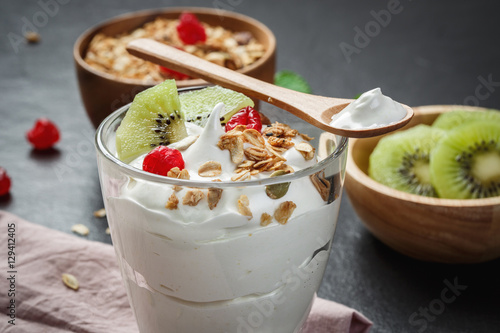 Greek yogurt with kiwi on black stone slab