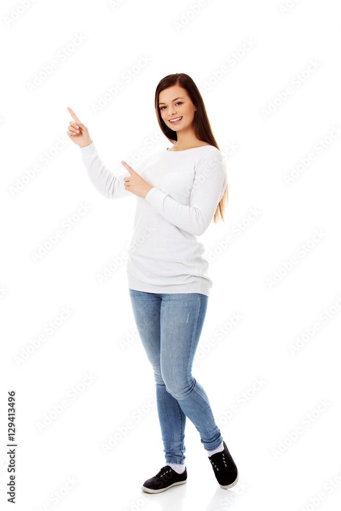 Smiling young woman shows something Smiling young woman shows something