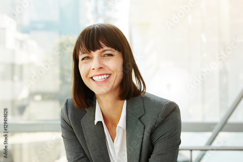 Close up portrait of happy stylish business woman in city