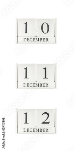 Closeup group of white wooden calendar with black 10 , 11 , 12 december word , three date calendar isolated on white background