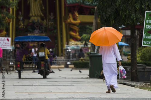 Buddhist with orange umbrella