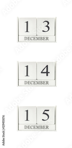 Closeup group of white wooden calendar with black 13 , 14 , 15 december word , three date calendar isolated on white background