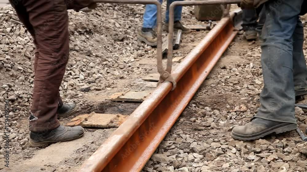 Railway workers bolting track rail Railway workers bolting track rail