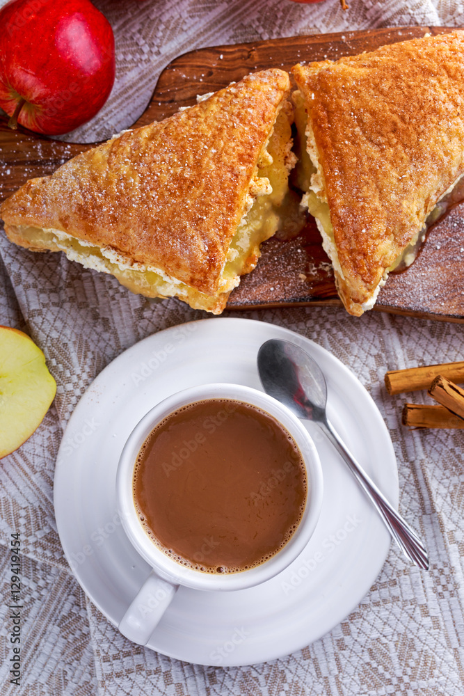 Puff pastry Turnovers apple cake dessert with whipped cream and hot coffee. Puff pastry Turnovers apple cake dessert with whipped cream and hot coffee.
