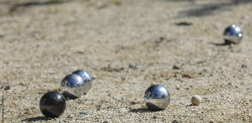 Metallic petanque three balls and a small wood jack Metallic petanque three balls and a small wood jack