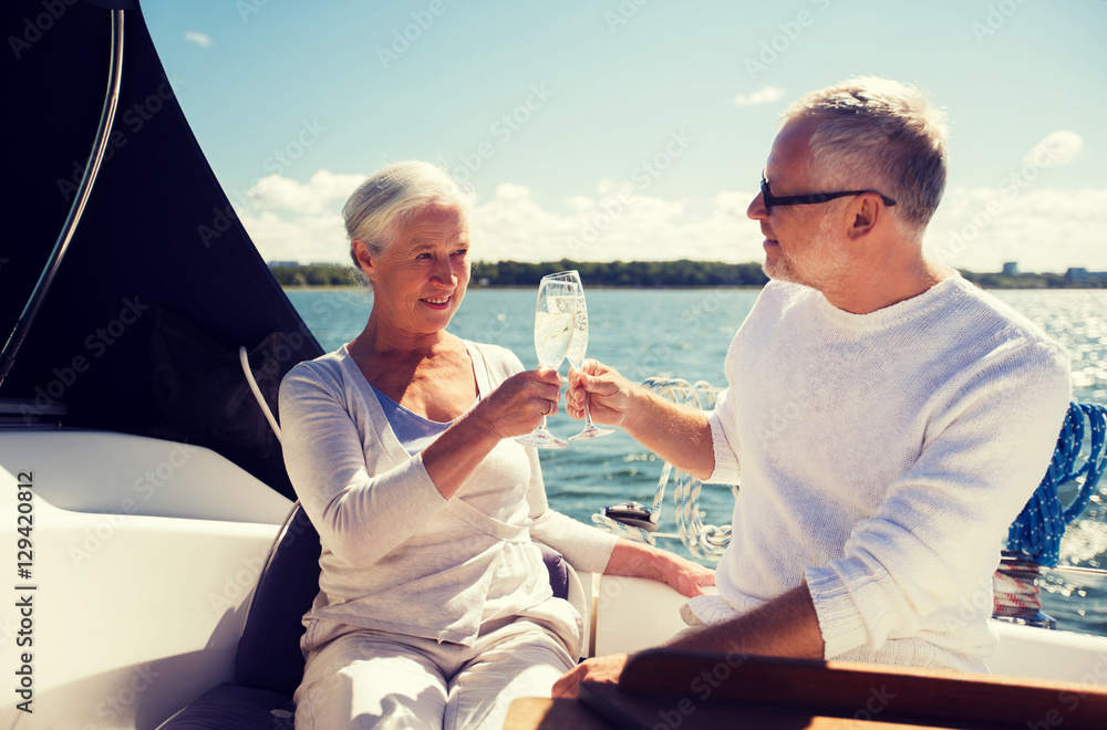 senior couple clinking glasses on boat or yacht senior couple clinking glasses on boat or yacht