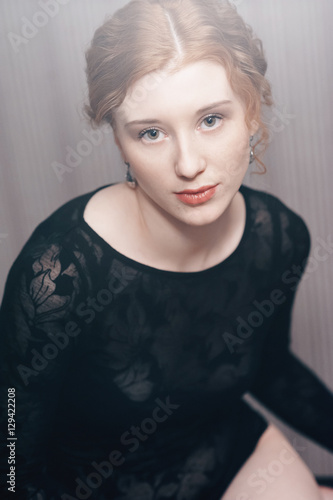 Elegant woman over dark background fashion photo.