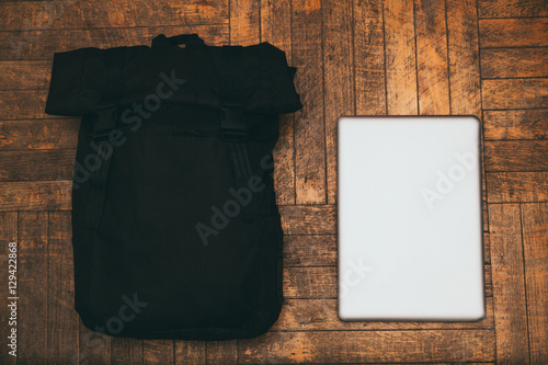 black briefcase and silver aluminum laptop lying on the boards