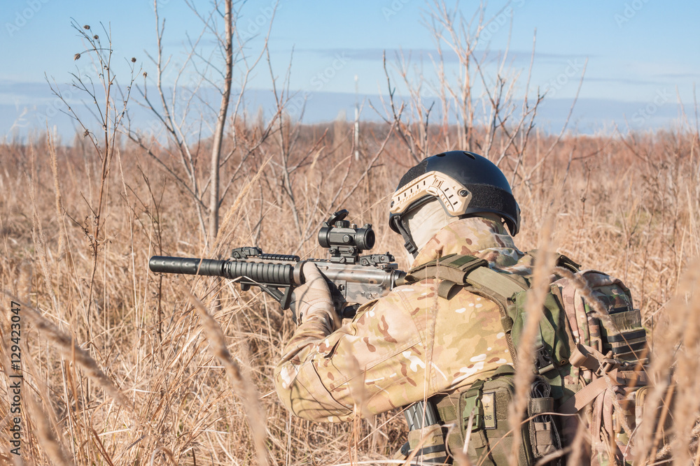 Fototapeta premium Airsoft Soldiers in ambushl during a military simulation training game back view