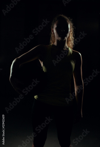 Young woman stands with the ball. © semenenkostas