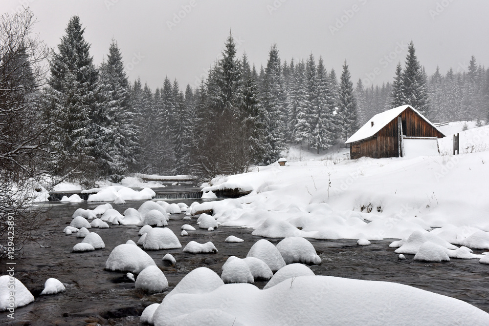 Mountain wooden chalet covered with fresh snow Mountain wooden chalet covered with fresh snow