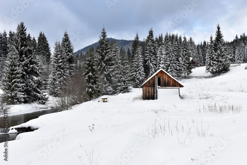 Alpine house covered with snow in the mountains