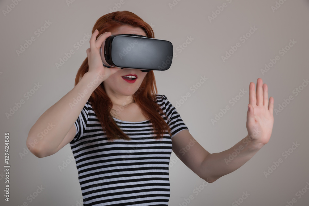 Attractive woman wearing virtual reality goggles. VR headset. Virtual reality concept Attractive woman wearing virtual reality goggles. VR headset. Virtual reality concept