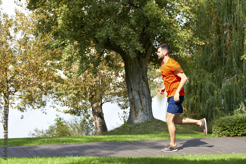 Morning run. Full length shot of a young man running outdoor in the park. Morning run. Full length shot of a young man running outdoor in the park.