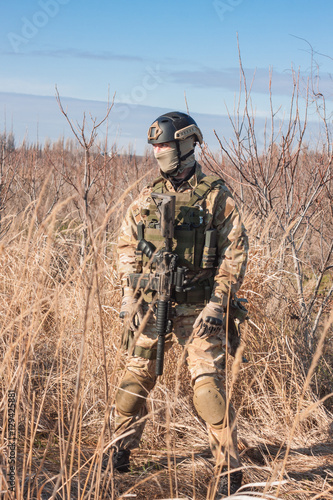 airsoft soldier with a rifle and full amunition