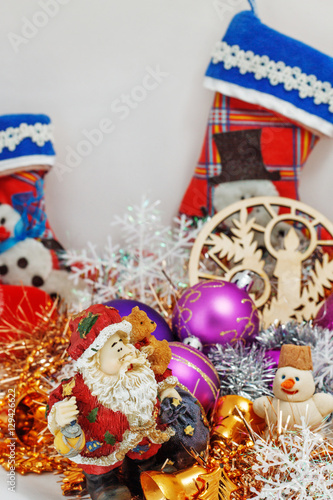Father Christmas (Santa Claus) with a snowman in the tinsel. among Christmas balls and Christmas decoration.