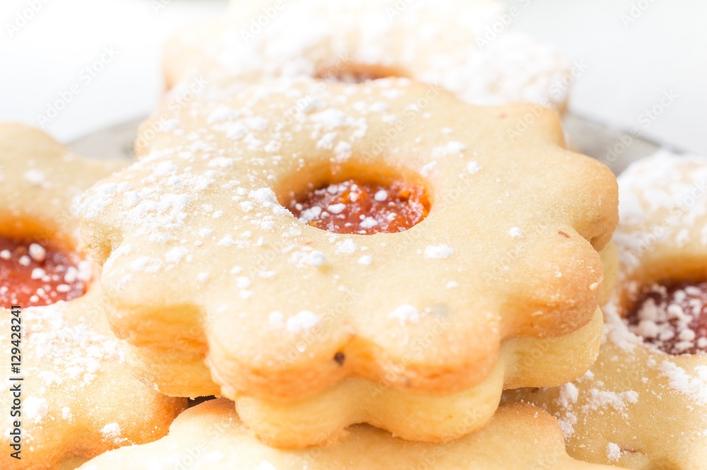 Homemade apricot jam Linzer with icing sugar close up