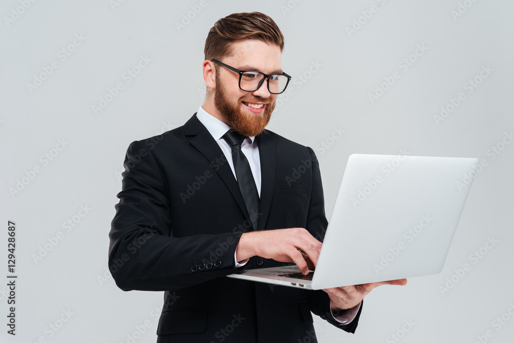 Business man in glasses holding laptop Business man in glasses holding laptop