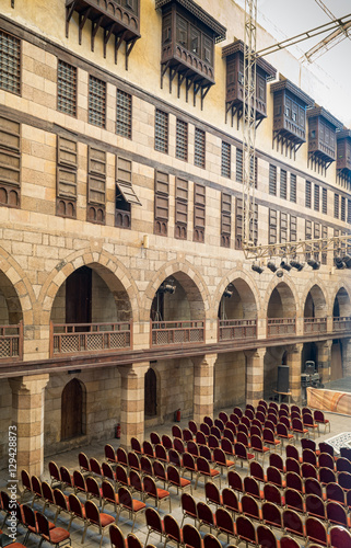 Courtyard of  caravansary (Wikala) of al-Ghuri, with five floors of vaulted arcades leading to storage rooms, and windows covered by interleaved wooden grids (mashrabiya), Medieval Cairo, Egypt photo