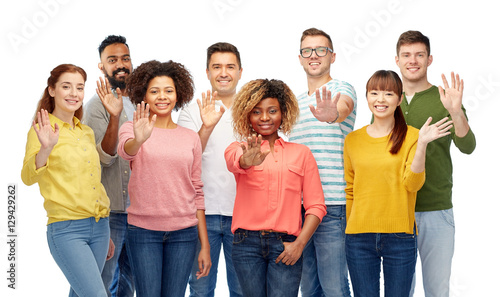 international group of happy people waving hand