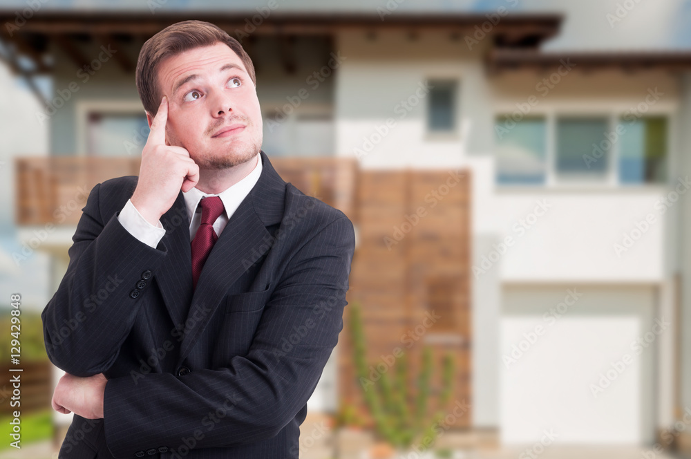 Real estate broker thinking at something Real estate broker thinking at something